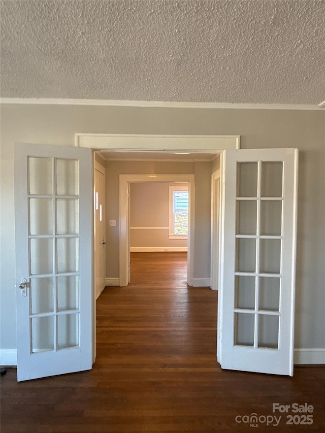 hallway featuring dark hardwood / wood-style flooring and a textured ceiling