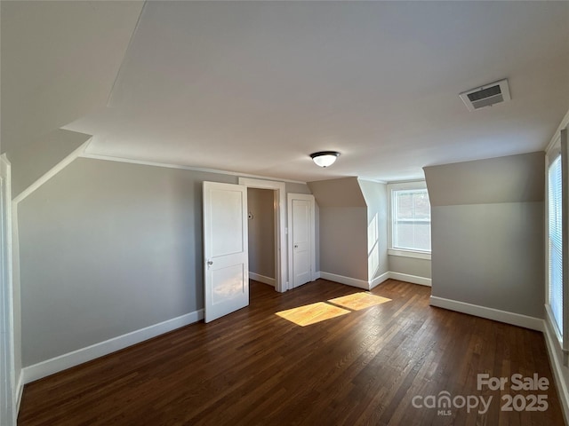 bonus room with dark hardwood / wood-style flooring