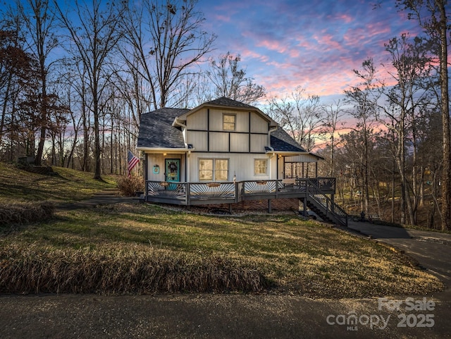 view of front facade featuring a yard and a deck