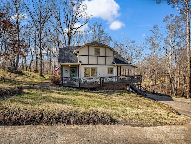 view of front of house with a deck and a front yard