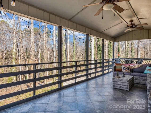 sunroom with vaulted ceiling, ceiling fan, and plenty of natural light