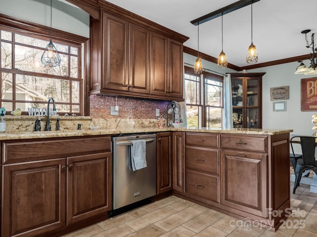 kitchen featuring sink, hanging light fixtures, stainless steel dishwasher, light stone countertops, and backsplash