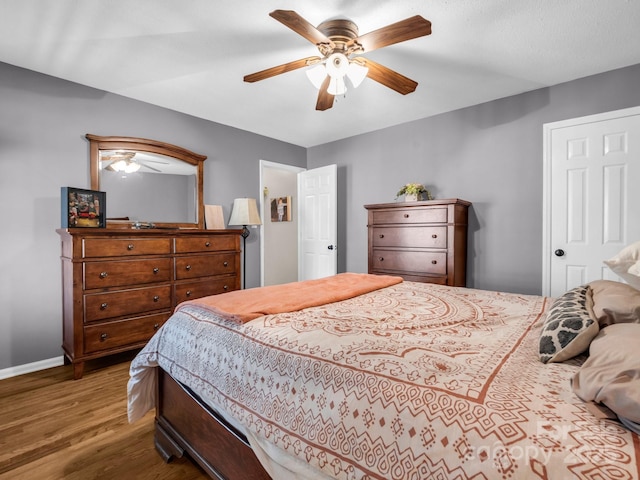 bedroom with dark wood-type flooring and ceiling fan