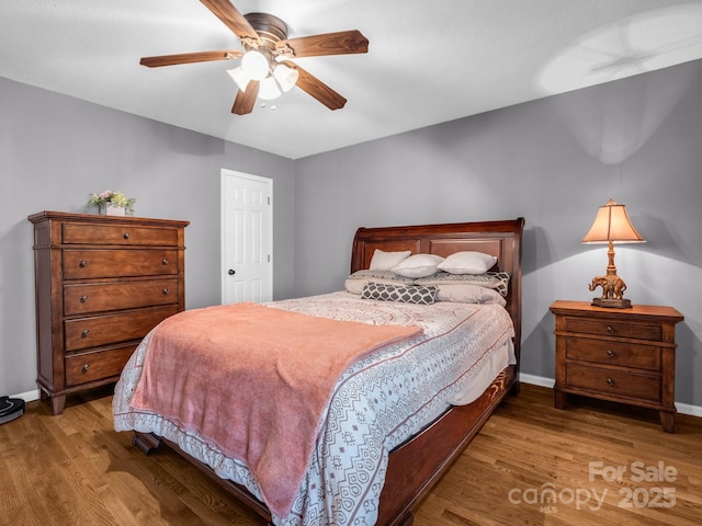 bedroom with hardwood / wood-style flooring and ceiling fan