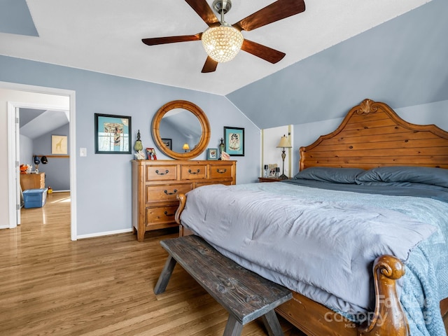 bedroom with lofted ceiling, ceiling fan, and light hardwood / wood-style flooring