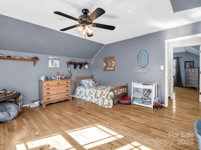 bedroom with hardwood / wood-style floors, vaulted ceiling, and ceiling fan