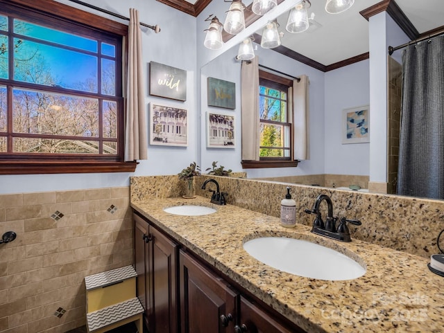 bathroom with crown molding, vanity, a shower with shower curtain, and tile walls