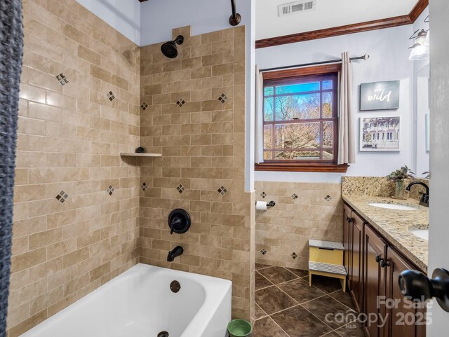 bathroom featuring tile walls, vanity, tile patterned floors, and tiled shower / bath