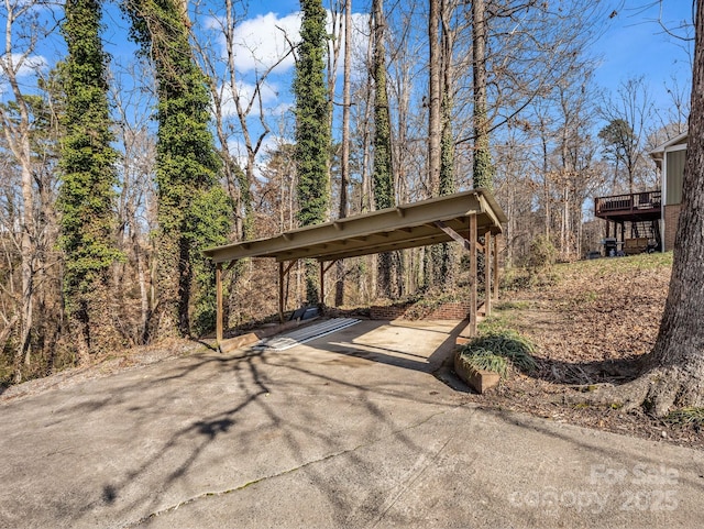 view of patio / terrace with a carport and a deck