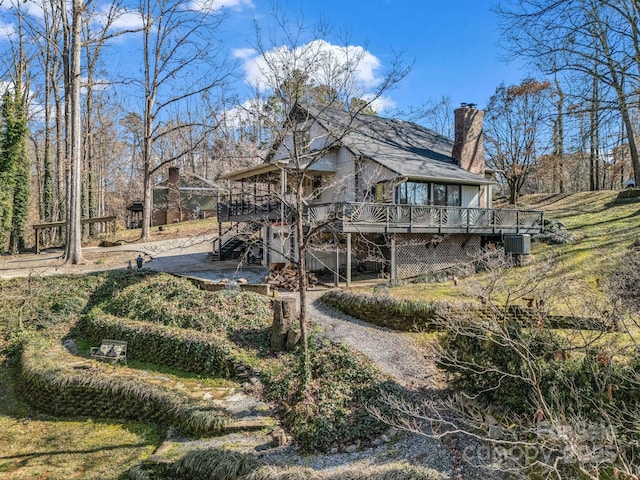 rear view of house with a wooden deck