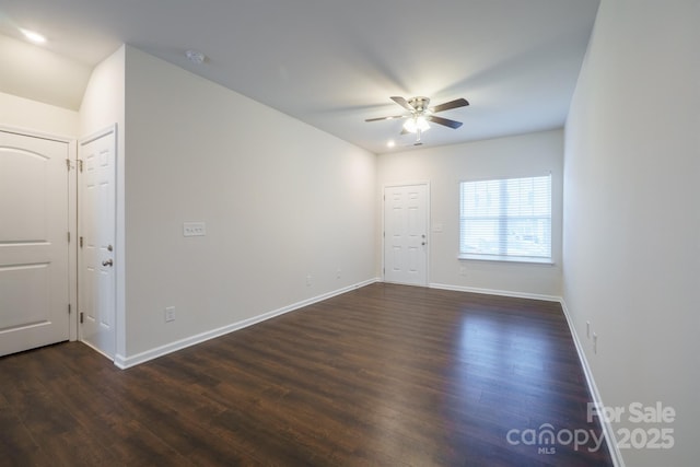 unfurnished room featuring dark wood-type flooring and ceiling fan