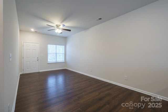 spare room featuring ceiling fan and dark hardwood / wood-style flooring