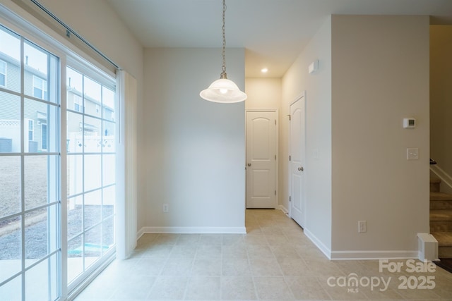 unfurnished dining area with light tile patterned floors