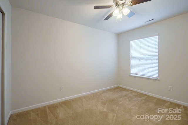 unfurnished room featuring light carpet and ceiling fan