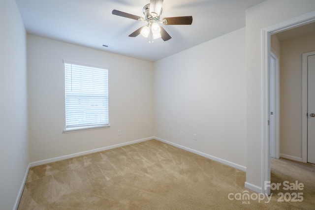 spare room with light carpet and ceiling fan