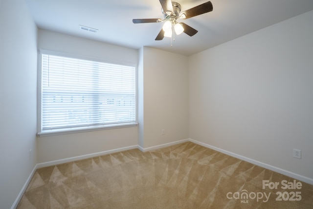 carpeted spare room with ceiling fan