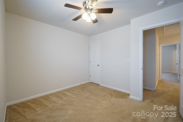 empty room featuring light colored carpet and ceiling fan