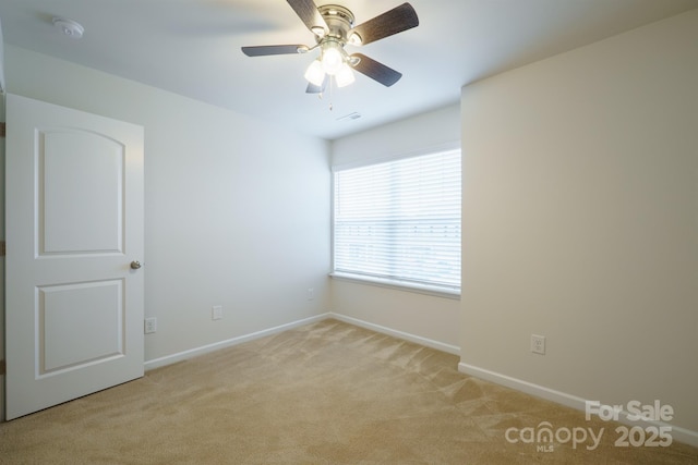 unfurnished room featuring light colored carpet and ceiling fan