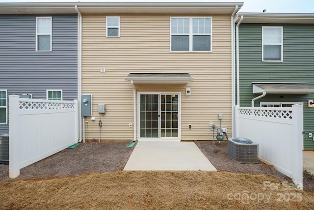 rear view of house featuring central AC unit and a patio area