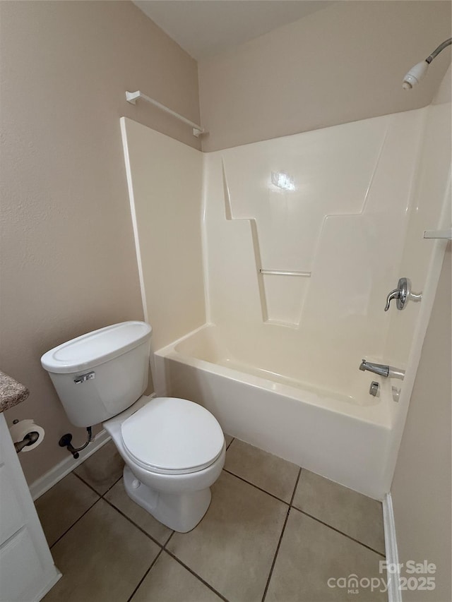 bathroom with tile patterned floors, toilet, and tub / shower combination