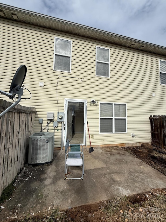 rear view of property featuring a patio area and central air condition unit