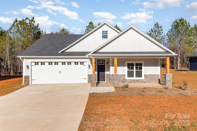 craftsman inspired home featuring a garage, covered porch, and a front lawn