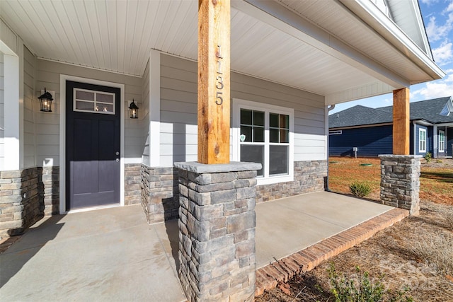 view of exterior entry featuring a porch