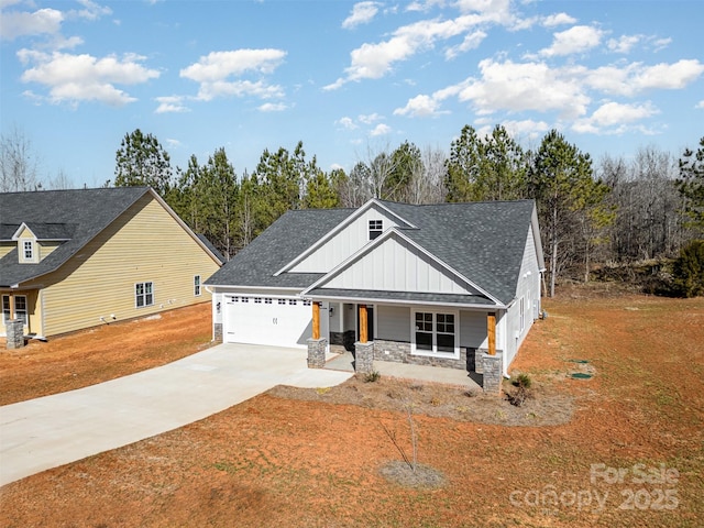 view of front of property featuring a garage, covered porch, and a front lawn