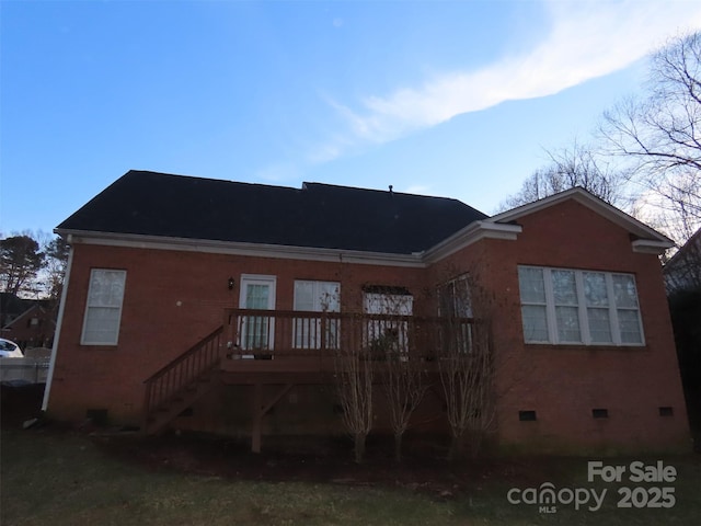 back of property with a wooden deck