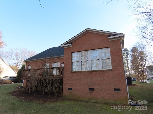 back of house with a wooden deck and a lawn