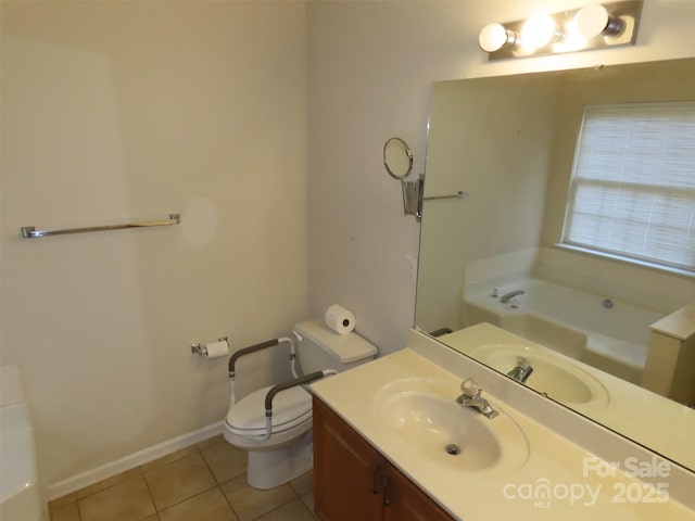 bathroom with vanity, tile patterned floors, toilet, and a bathing tub