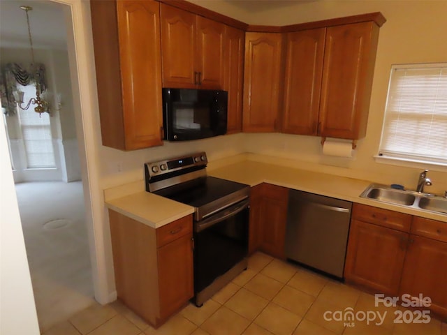 kitchen featuring sink, a wealth of natural light, light tile patterned flooring, and appliances with stainless steel finishes