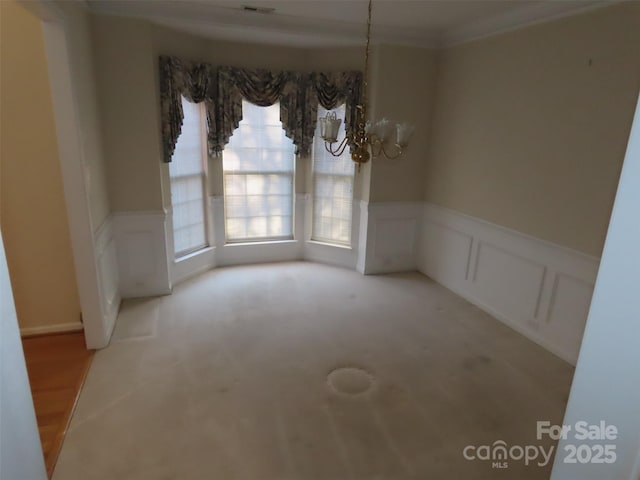 unfurnished room featuring a chandelier