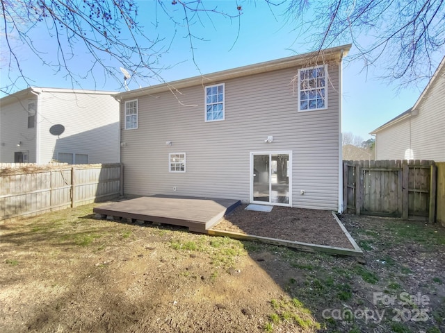 rear view of property featuring a yard and a deck