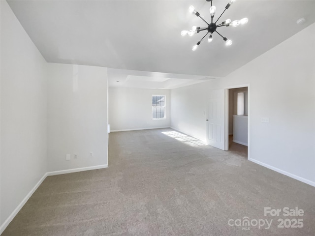 carpeted spare room featuring lofted ceiling and a notable chandelier