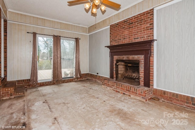 unfurnished living room with crown molding, a brick fireplace, a textured ceiling, and ceiling fan