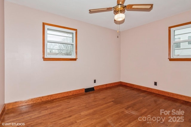 spare room featuring hardwood / wood-style floors and ceiling fan