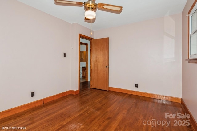 unfurnished room featuring dark hardwood / wood-style floors and ceiling fan