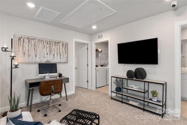 office area with light colored carpet and washer and dryer