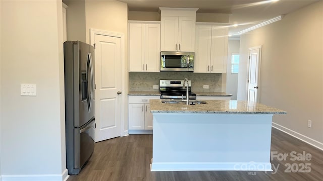 kitchen with white cabinetry, a center island with sink, appliances with stainless steel finishes, and a sink