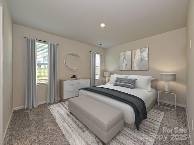 carpeted bedroom with visible vents and baseboards