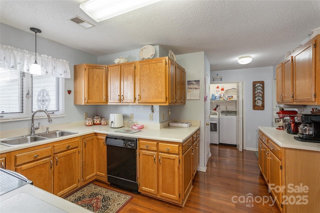 kitchen featuring decorative light fixtures, dishwasher, separate washer and dryer, sink, and dark hardwood / wood-style flooring