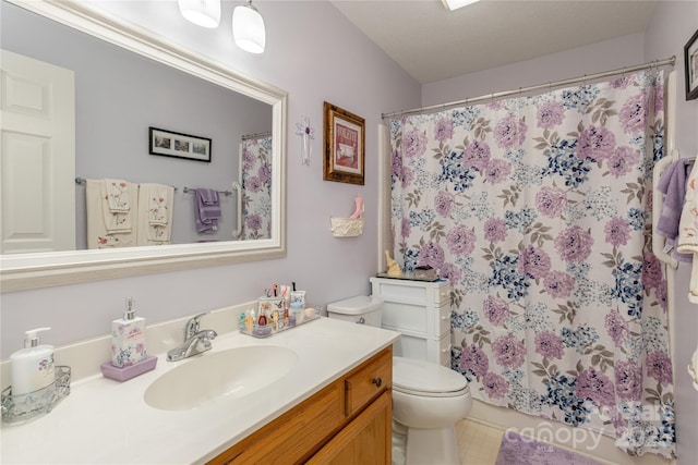 bathroom featuring vanity, curtained shower, and toilet