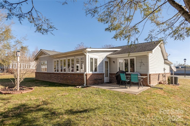 back of property with a patio, cooling unit, and a lawn