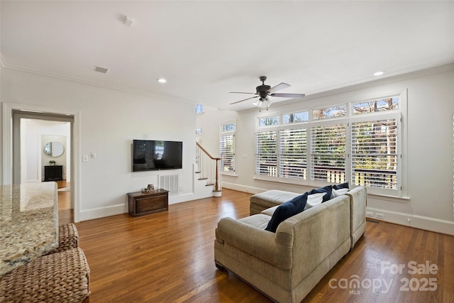 living room with ceiling fan, ornamental molding, and wood-type flooring