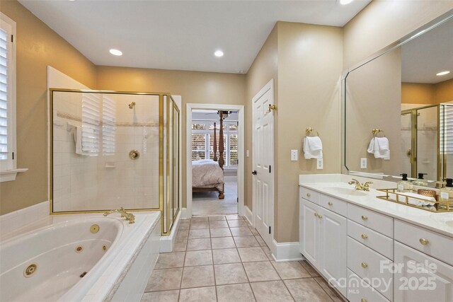 bathroom featuring tile patterned floors, shower with separate bathtub, and vanity