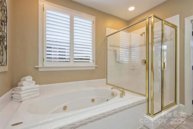 bathroom featuring separate shower and tub