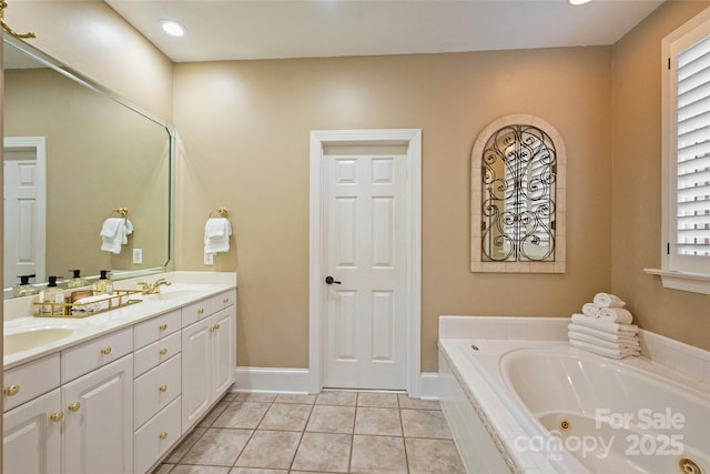 bathroom featuring a relaxing tiled tub, vanity, plenty of natural light, and tile patterned floors