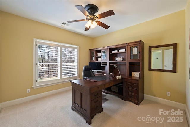 office space featuring ceiling fan and light colored carpet