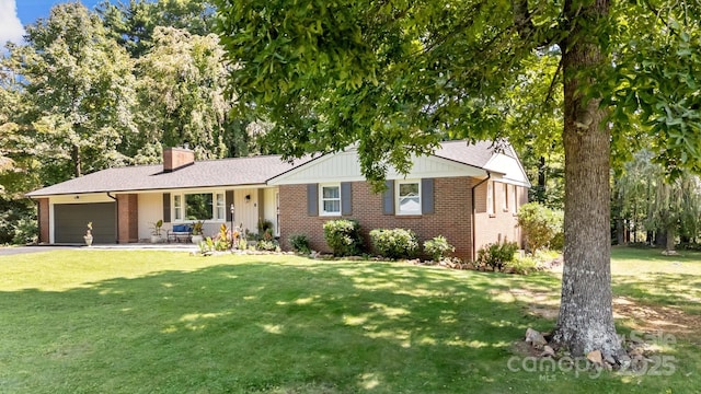 single story home featuring a garage and a front yard